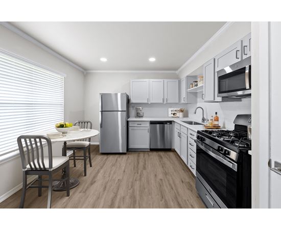 a kitchen with white cabinetry and stainless steel appliances at Sunset Heights, San Antonio, TX, 78209